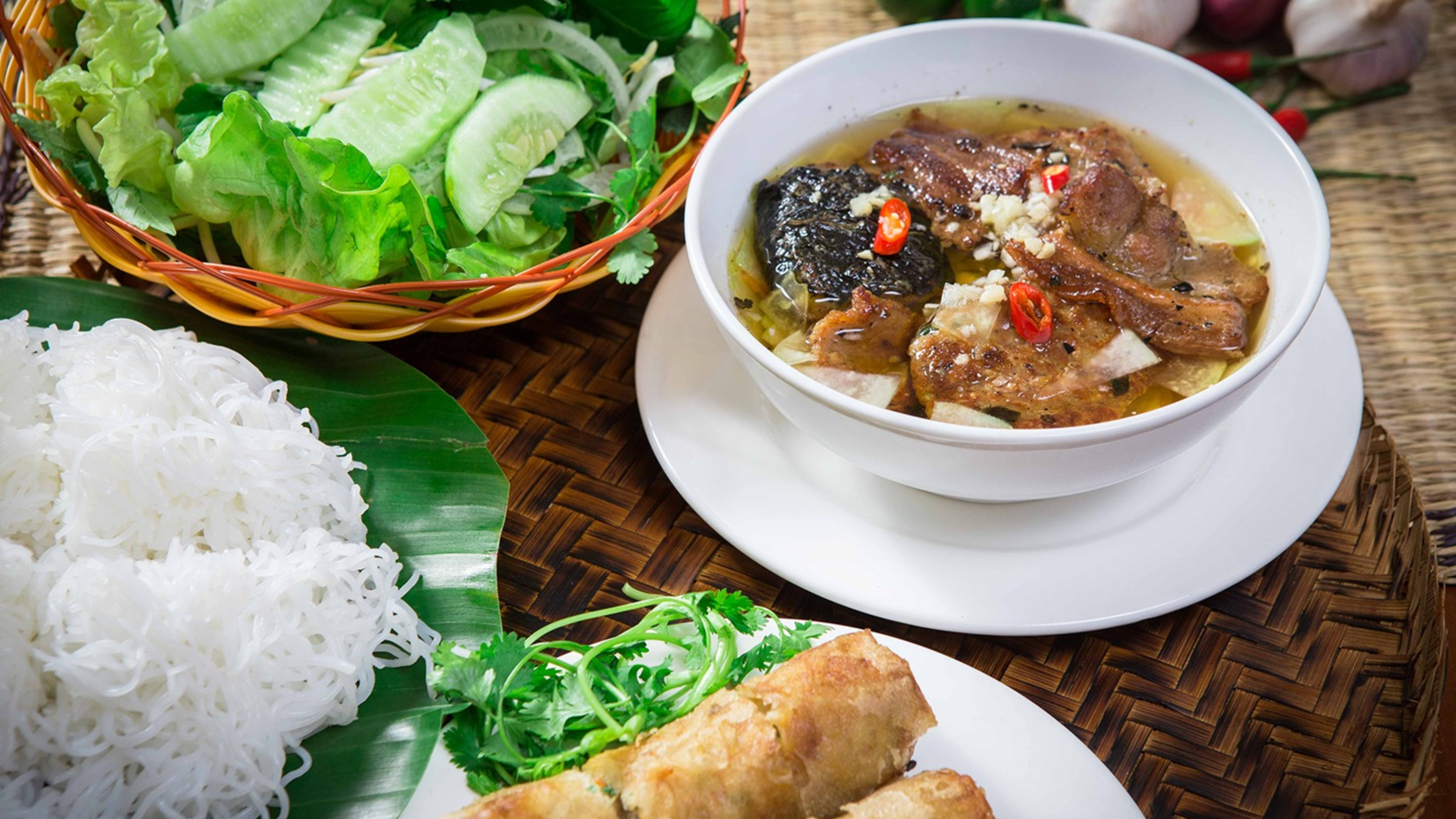 A traditional Vietnamese bun cha with grilled pork, herbs, and vermicelli, one of the best things to try in Hanoi